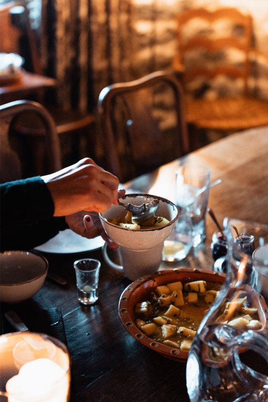 A chef-made meal being served in small bowls.